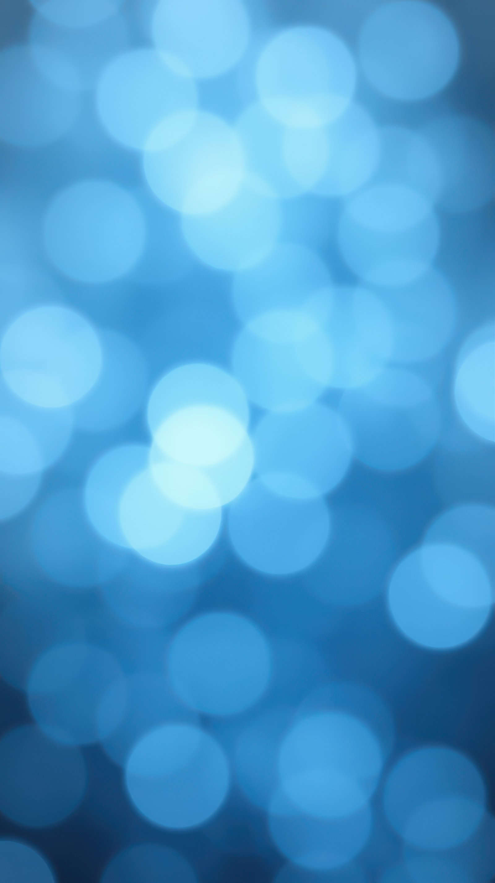 Bright blue bokeh lights create a soothing and dreamy atmosphere perfect for backgrounds and design